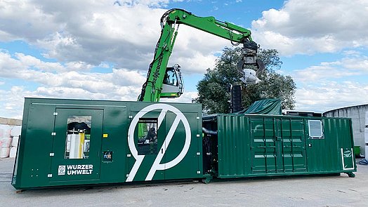 IW300-C docked to an ABBA bale press during loading.