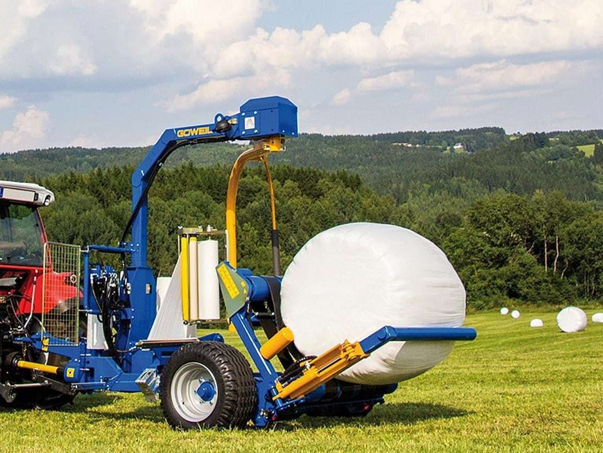 The bale is gently dropped towards the rear.