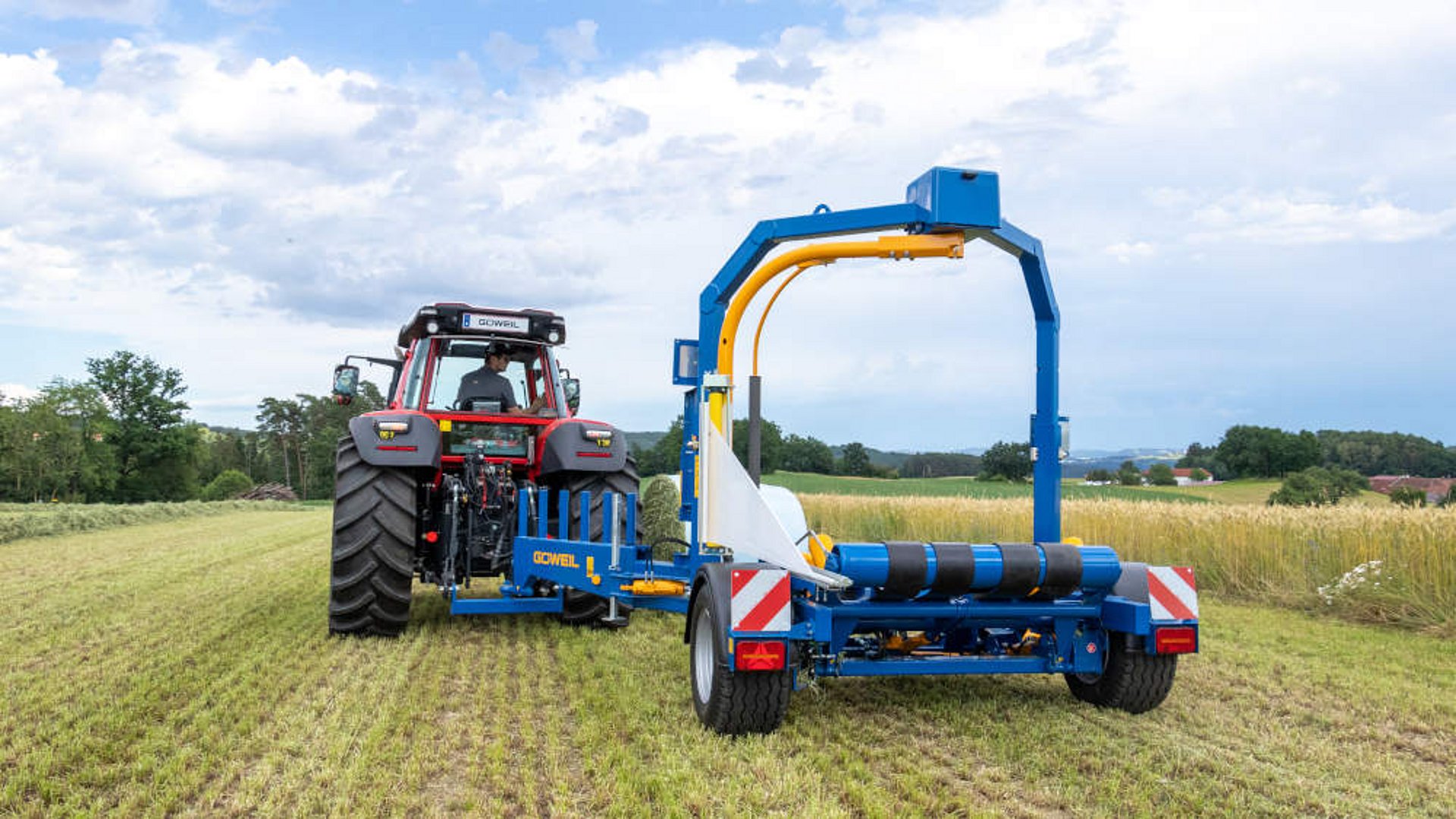 L’enrubanneuse est basculée au début en position de travail, déportée vers la droite derrière le tracteur.