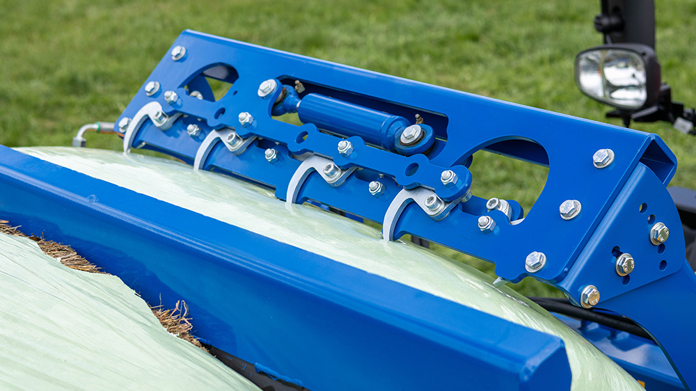 The eight hooks sink into the bale